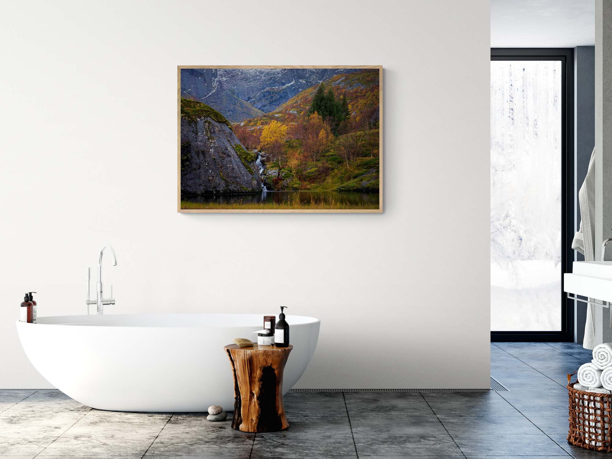 Small waterfall flowing into a pond amidst colorful autumn trees in Nusfjord, Lofoten, with rugged cliffs in the background.