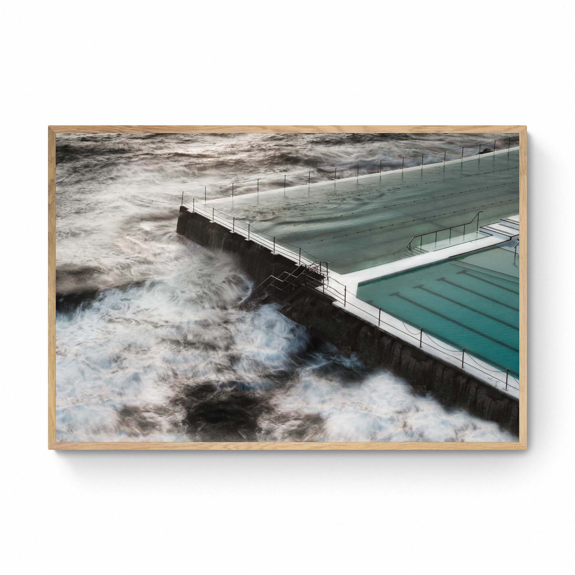 Long exposure of the Bondi Rock Pool in Sydney, with swirling ocean waves surrounding the calm waters of the pool.