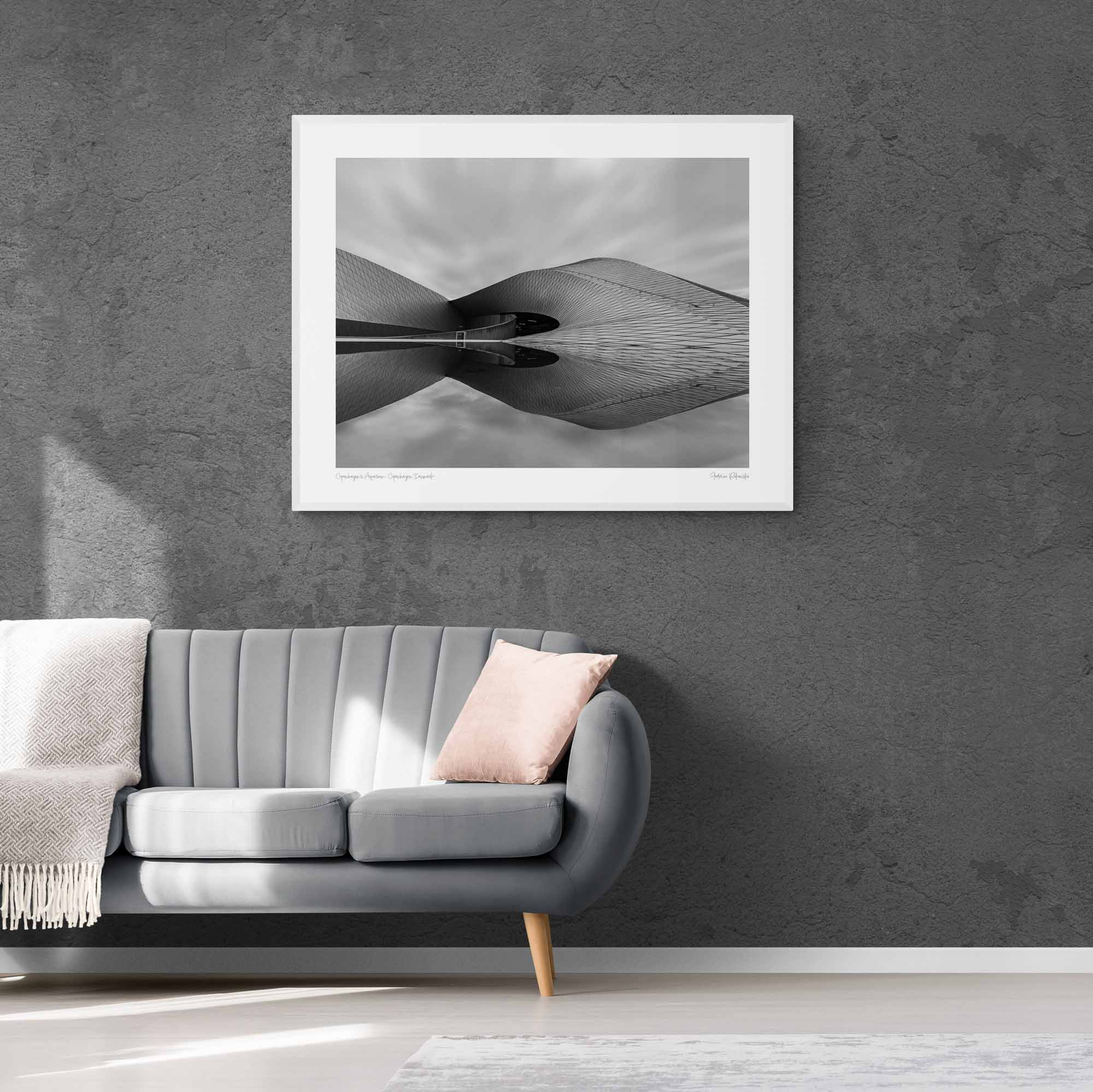 Black and white image of The Blue Planet Aquarium in Copenhagen with its reflective, wavy facade against a blurred sky.