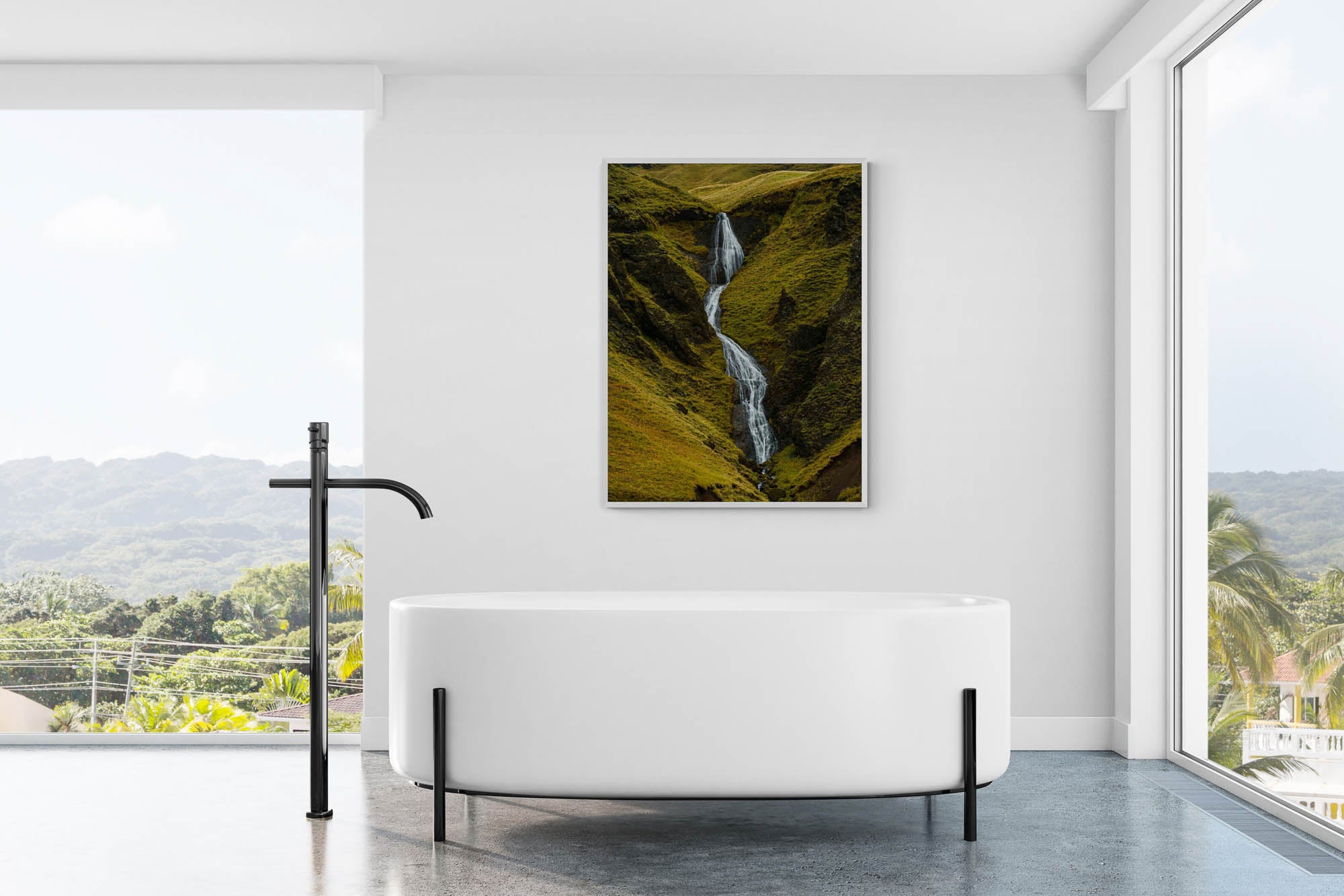 A hidden waterfall flows through the green, mossy cliffs of Fjaðrárgljúfur canyon in Iceland.