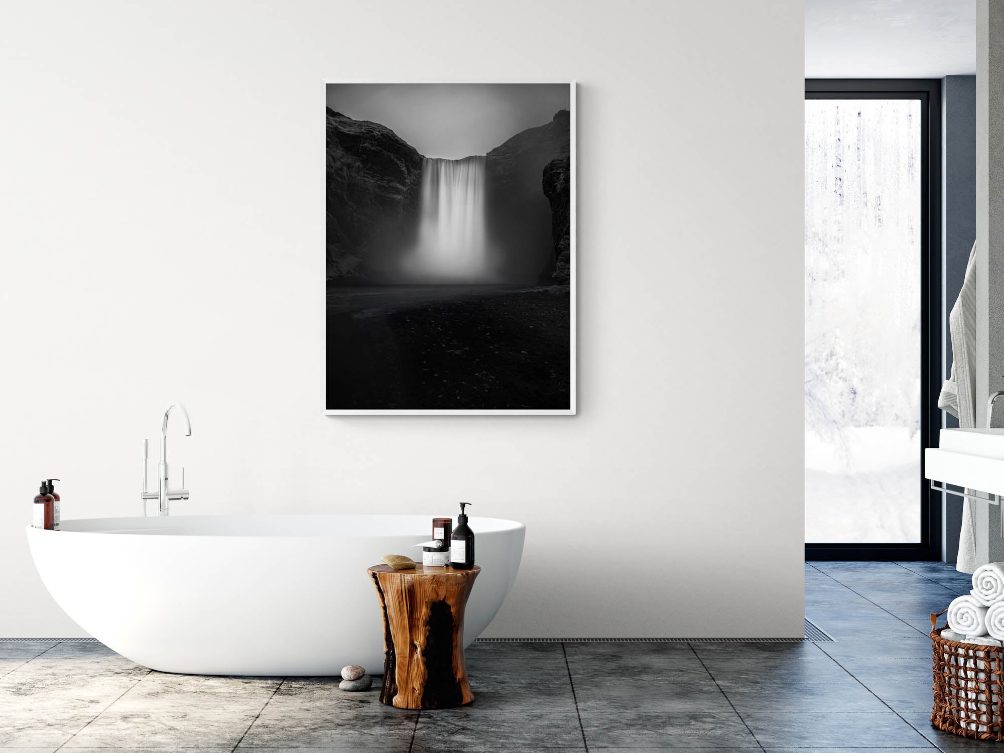 A long exposure photograph of Skógafoss waterfall in Iceland, rendered in stunning black and white, capturing the smooth flow of water between two dark cliffs.