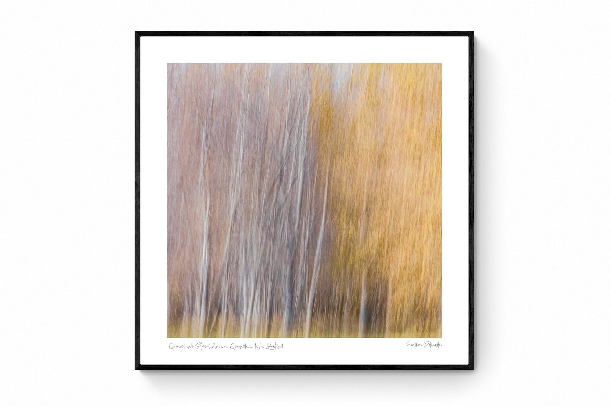 Abstract, blurred image of autumn trees in Queenstown, resembling an impressionistic painting with soft white and golden strokes.