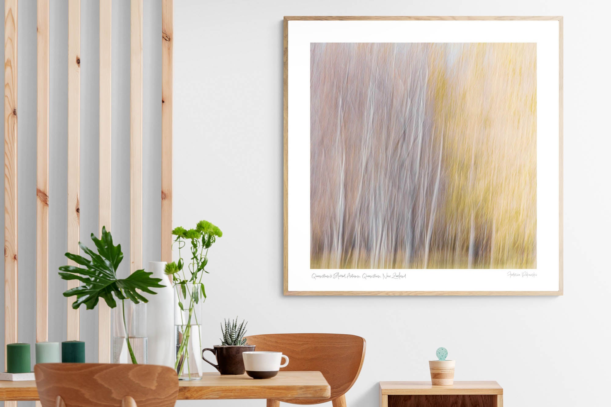 Abstract, blurred image of autumn trees in Queenstown, resembling an impressionistic painting with soft white and golden strokes.