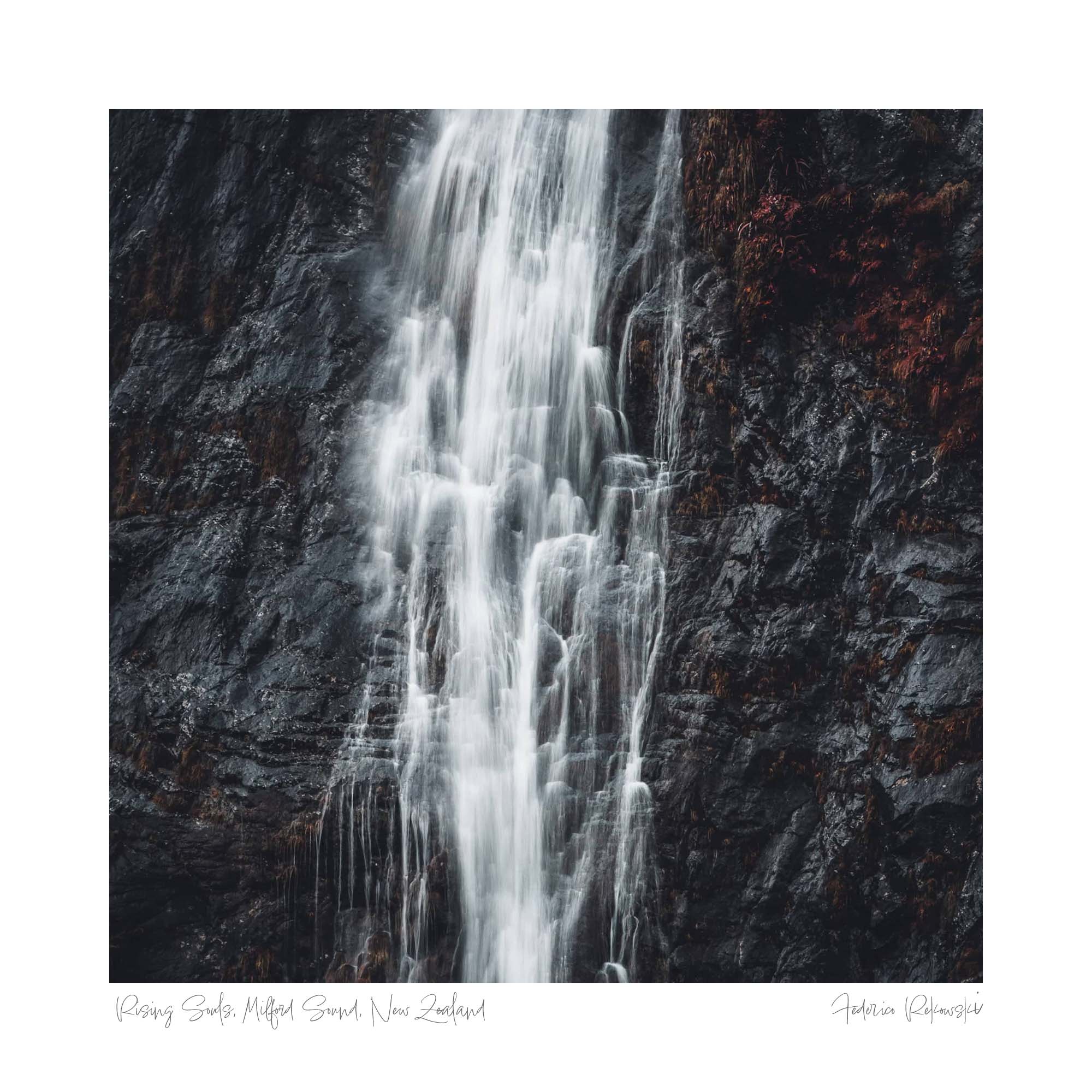 A waterfall cascades down a rugged cliff, a misty dance of water called "Rising Souls" in Milford Sound, New Zealand.