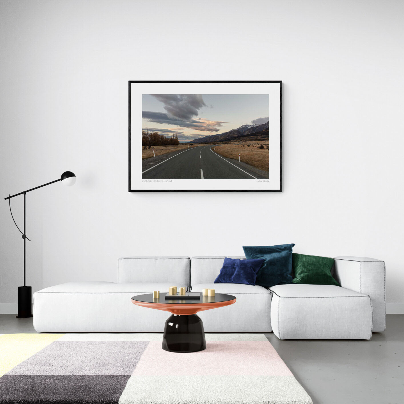 A serene landscape photograph of a road in New Zealand with Aoraki/Mt Cook in the background under a twilight sky with dynamic cloud formations.