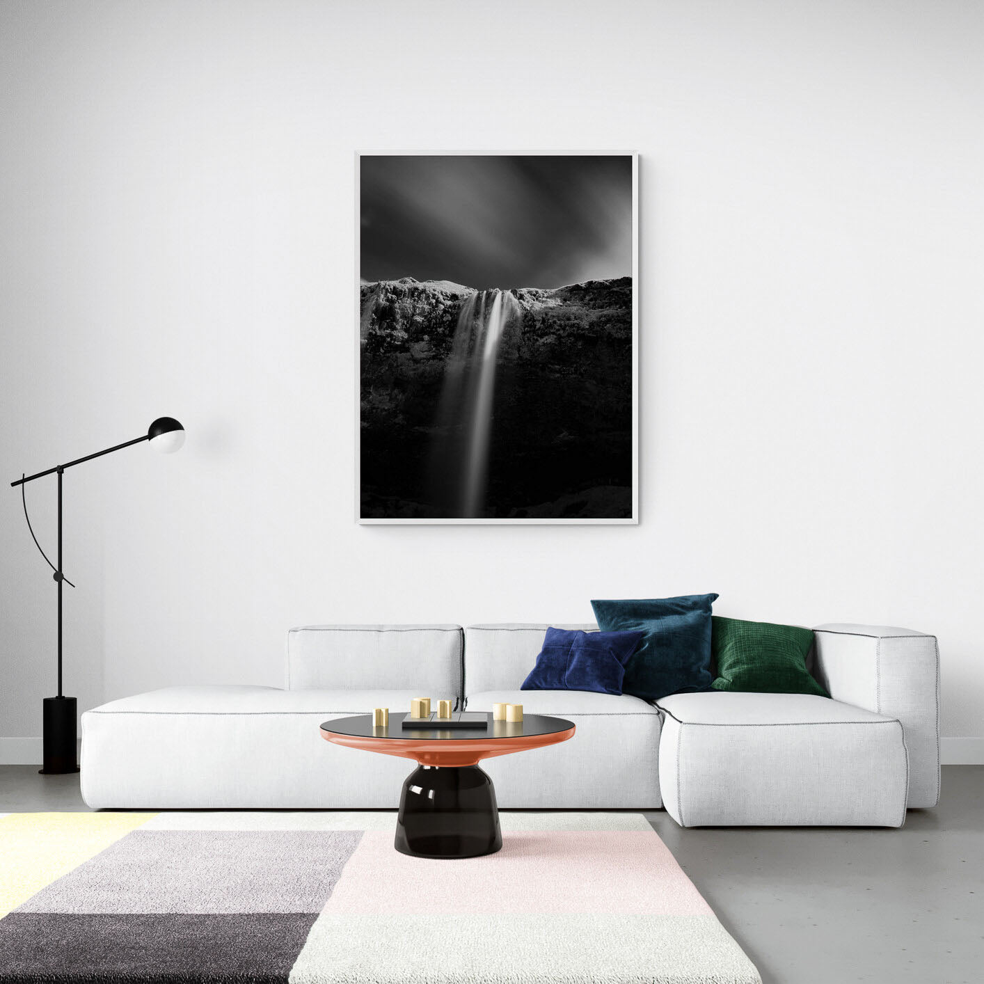 A black and white long-exposure photograph of Seljalandsfoss waterfall in Iceland, showing smooth water streams against a dark, textured cliff.