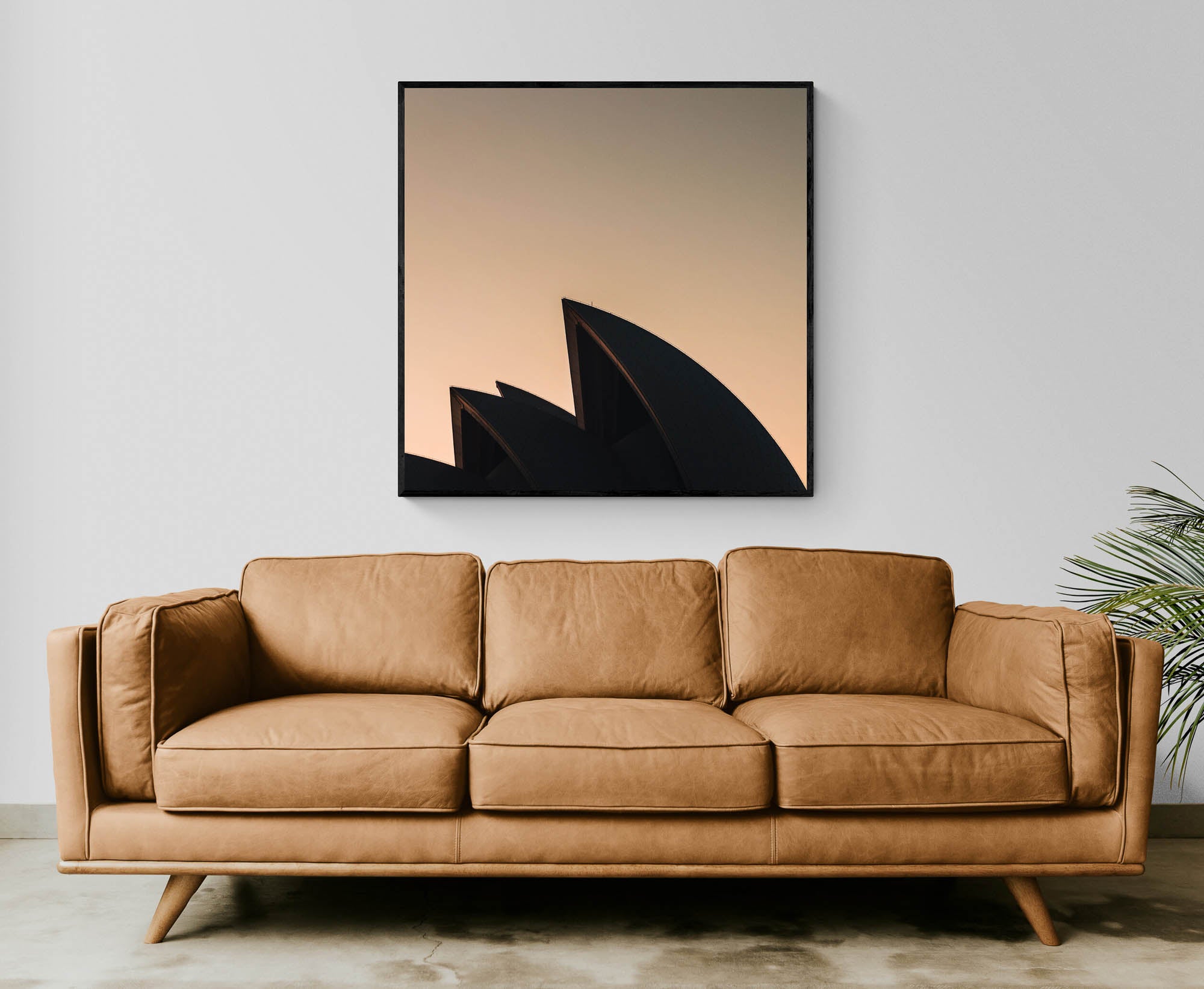 The iconic sails of the Sydney Opera House in silhouette against the warm tones of sunrise.