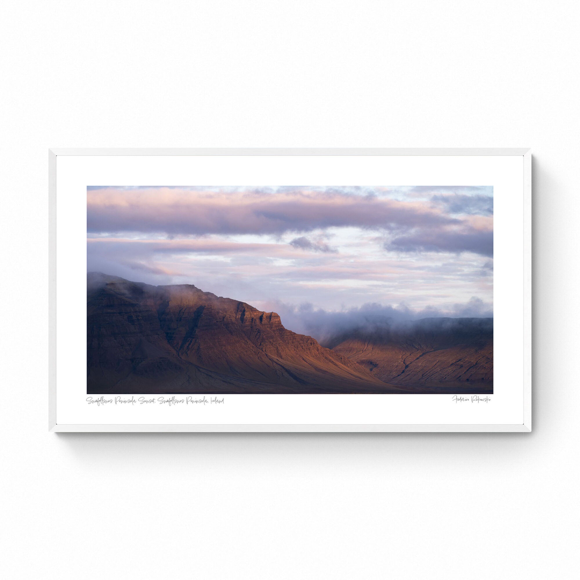 Late evening light bathes the Snæfellsnes Peninsula mountains in a warm glow with pink-tinged clouds above in Iceland.