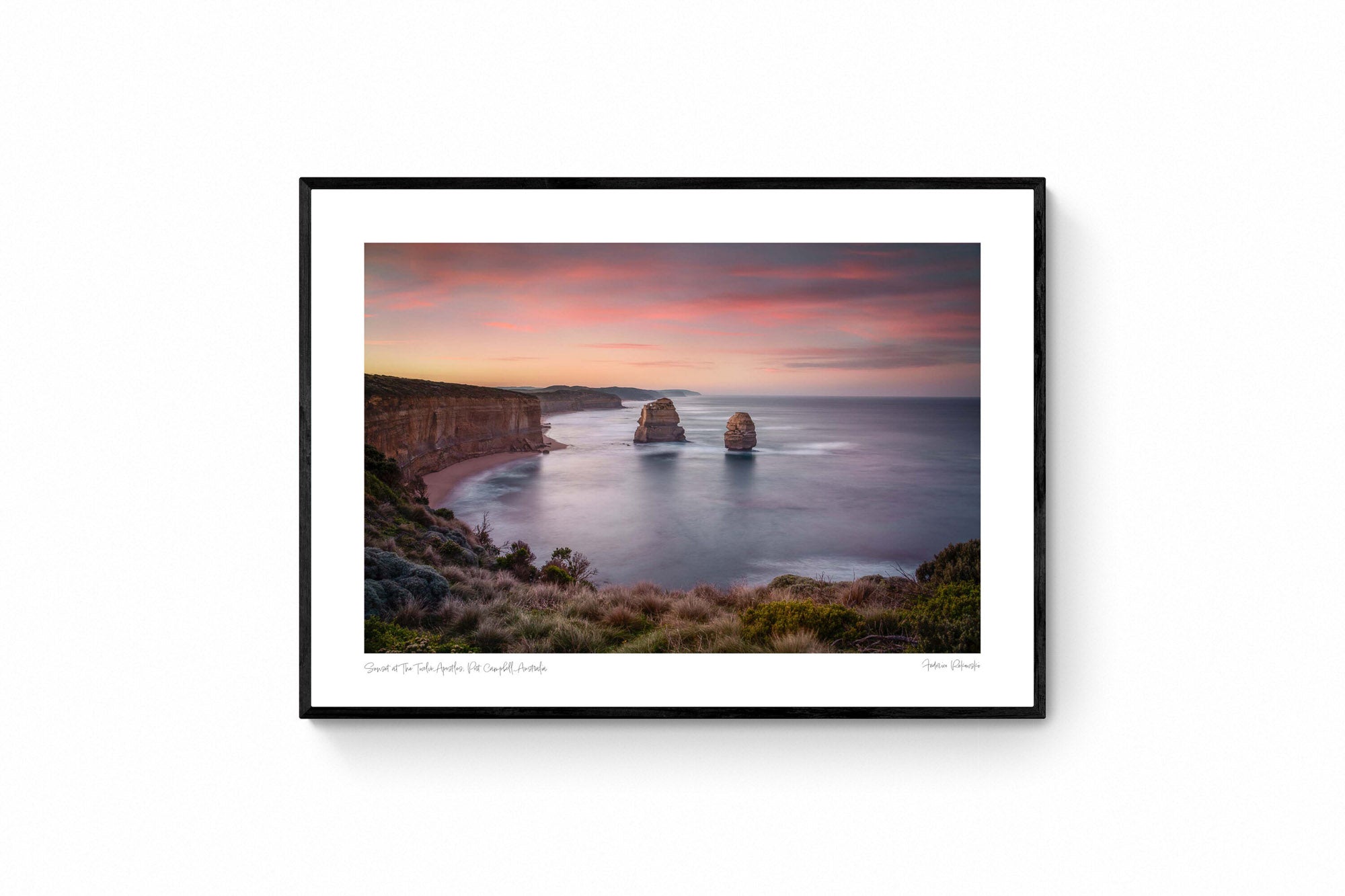 Sunset at The Twelve Apostles, with smooth seas and pastel skies highlighting the limestone formations off Australia's coast.