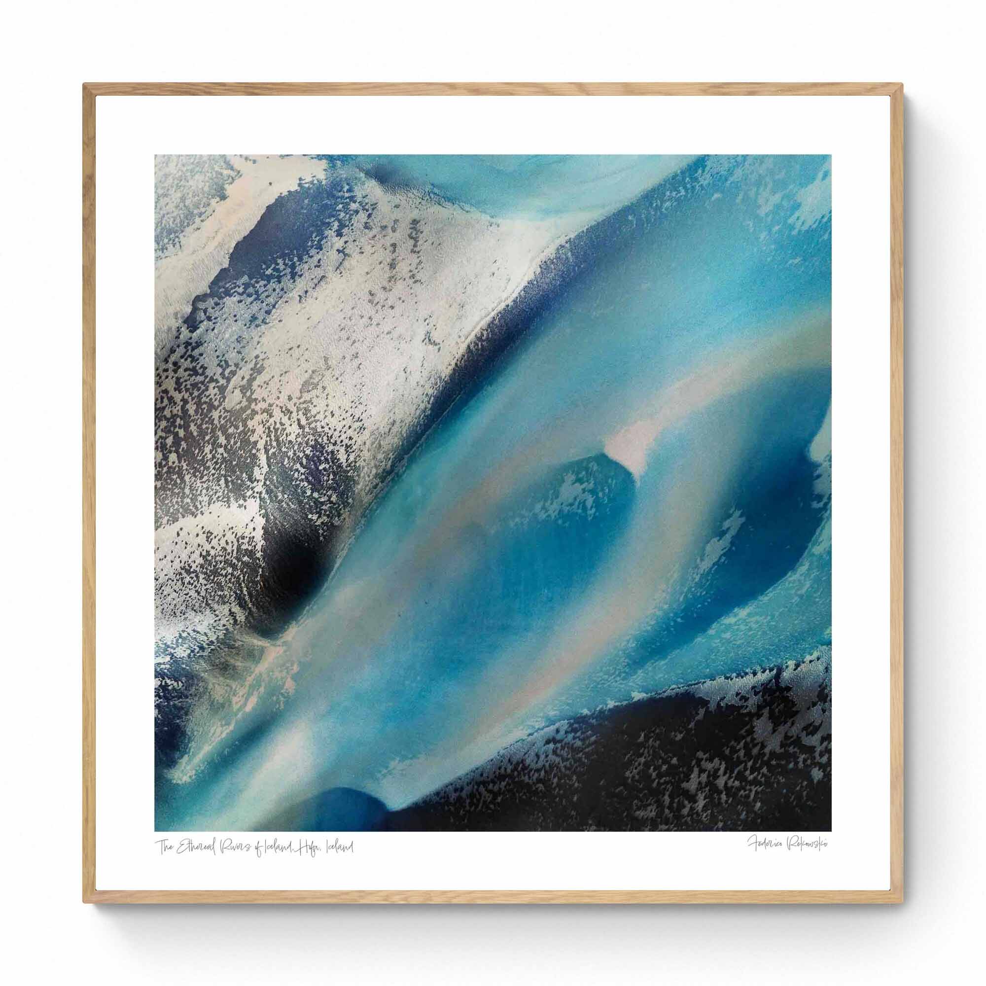 Overhead shot of contrasting blue glacial streams and ashy mountain terrain in an abstract Icelandic landscape.