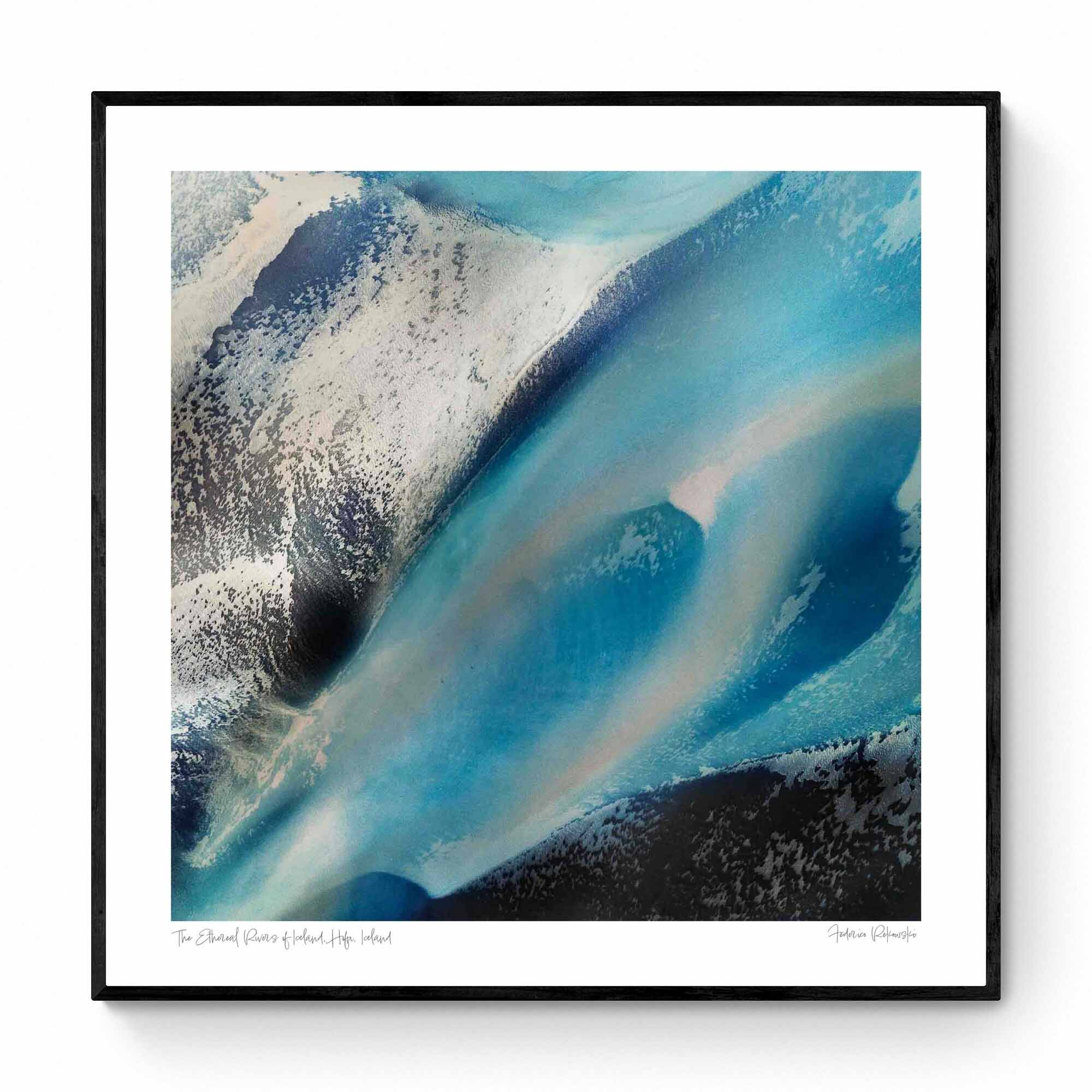 Overhead shot of contrasting blue glacial streams and ashy mountain terrain in an abstract Icelandic landscape.