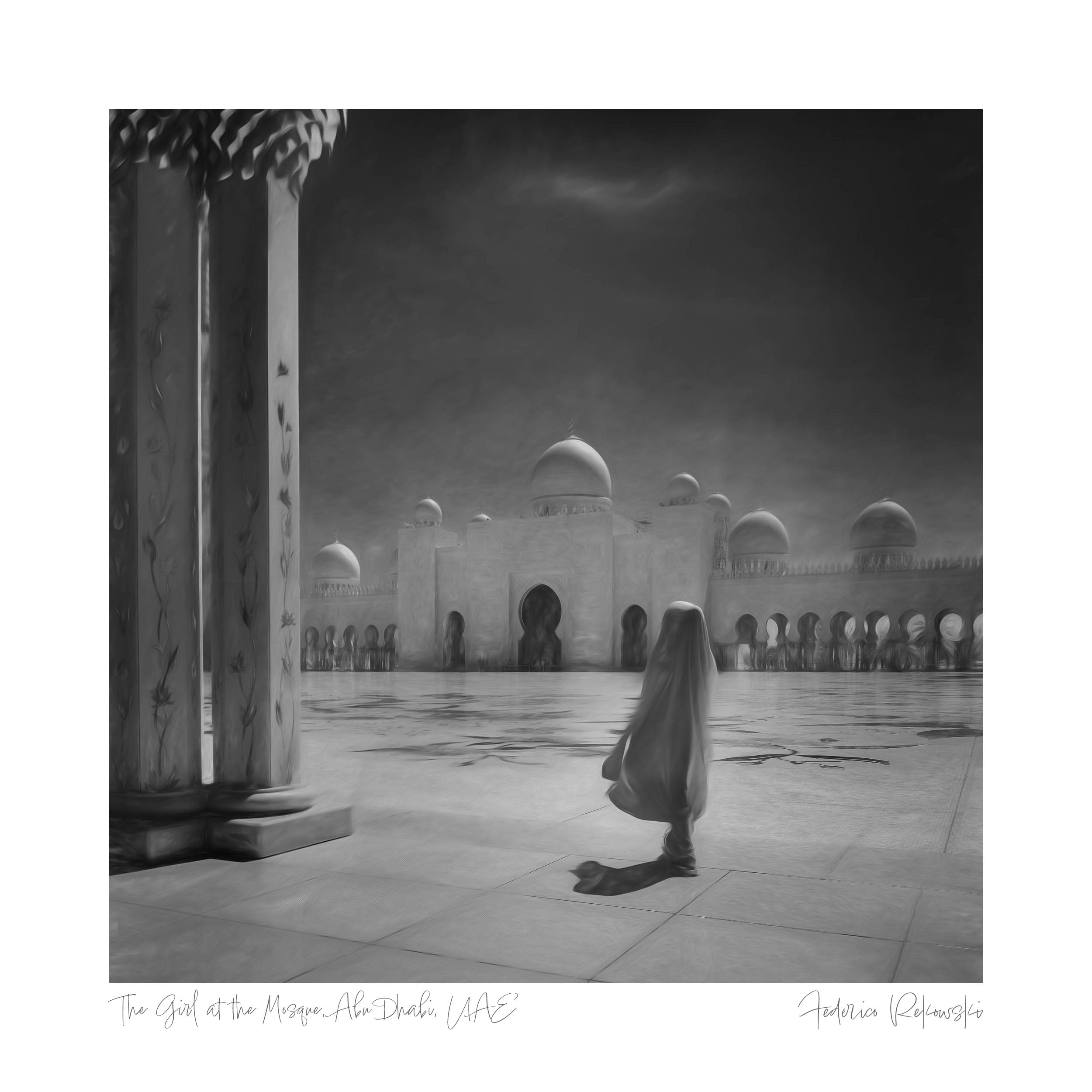 A woman in traditional attire stands alone amidst the grandeur of the Grand Mosque in Abu Dhabi, portrayed in black and white.