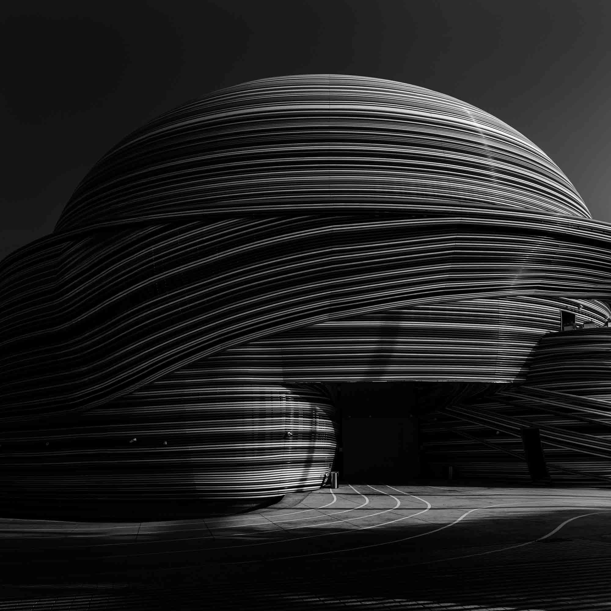 Black and white photo showcasing the striking, layered lines of the Russia Pavilion in Dubai.