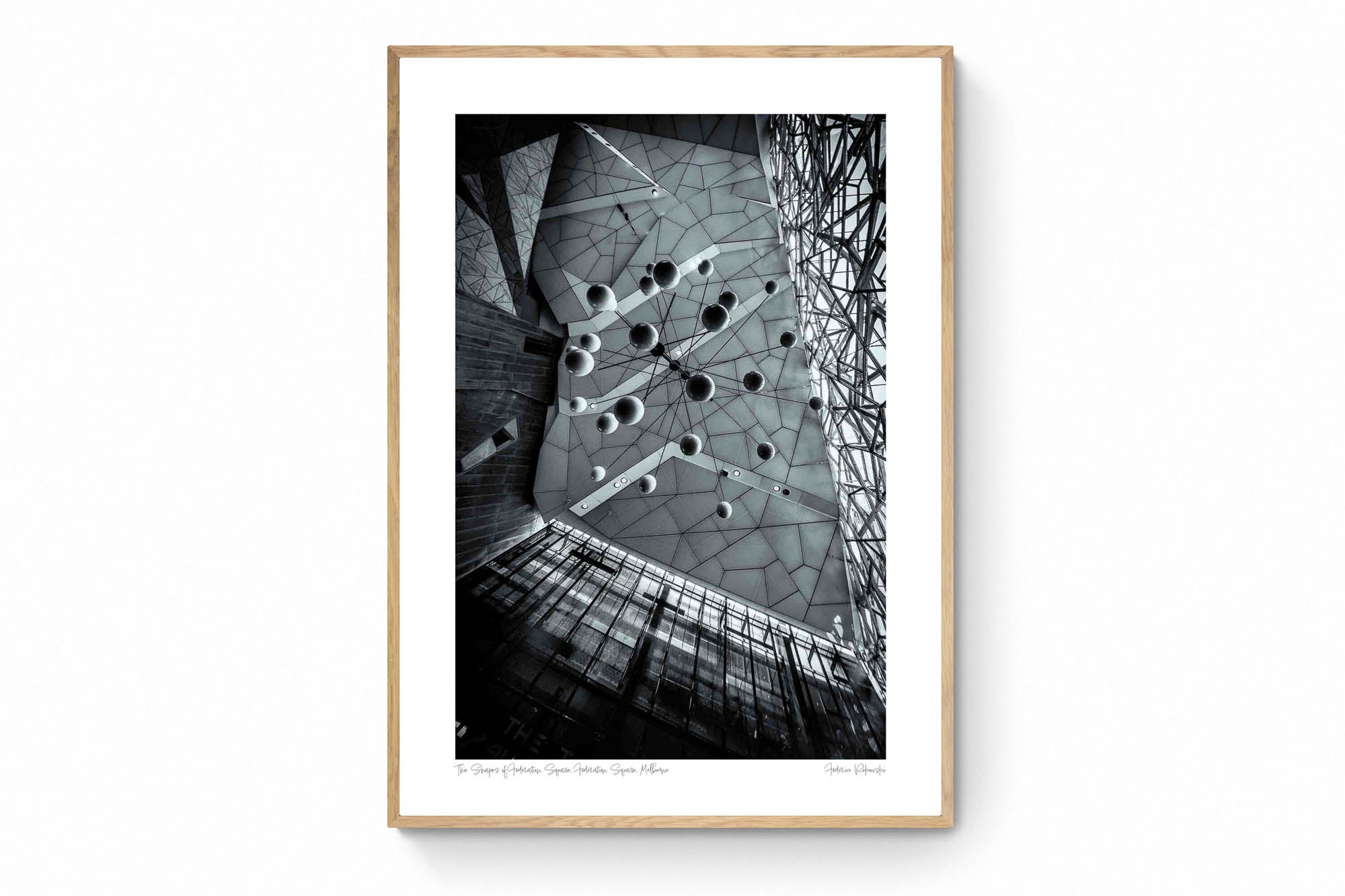 Black and white photo of the abstract geometric ceiling at Federation Square in Melbourne, with spherical elements hanging against the angular design.