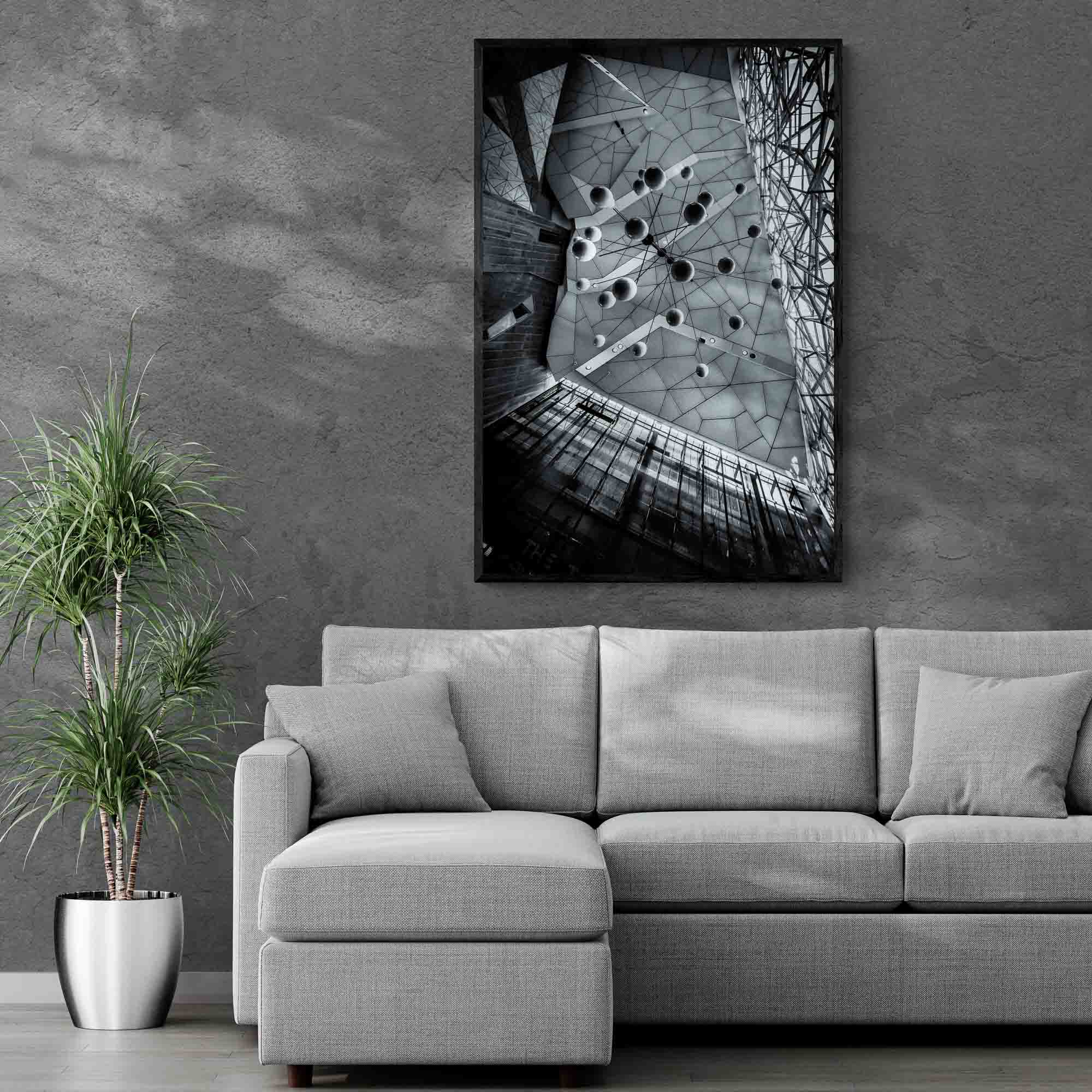 Black and white photo of the abstract geometric ceiling at Federation Square in Melbourne, with spherical elements hanging against the angular design.